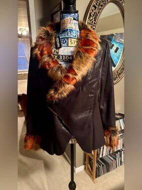 Dark brown pleather , faux fur lined , never worn . Trimmed in faux fur collar